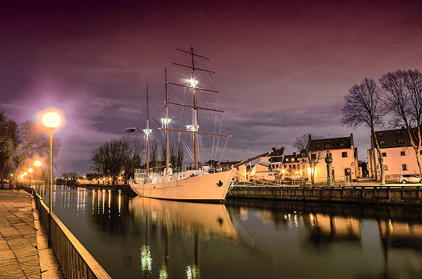 Klaipeda (Lithuania) in the evening. Old Town and Dane river. Ship Meridianas, 1948, the symbol of Klaipeda city
