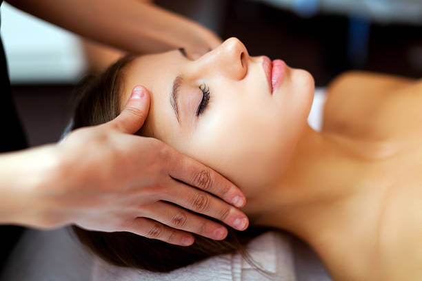 istock Woman receiving a temple massage 463498777