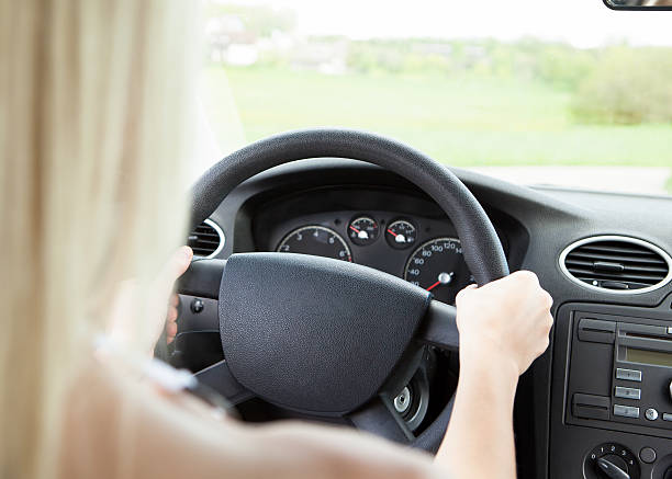 istock Female Hand Holding Steering Wheel 463499973