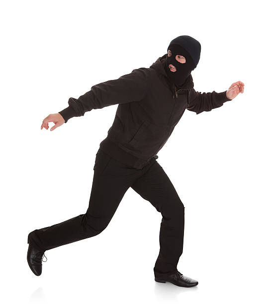 Bandit In Black Mask Running Away Man Wearing Mask Running Over White Background runaway stock pictures, royalty-free photos & images