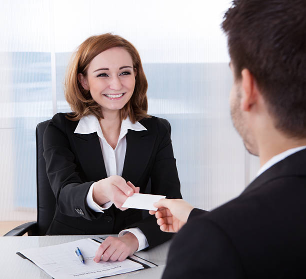 istock Two businesspeople exchanging visiting card 463504947