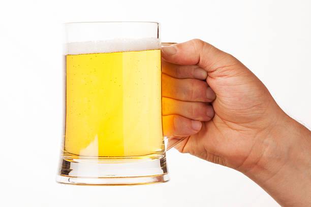 istock hand holding glass of beer 463506797