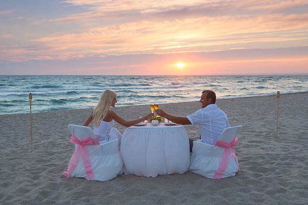 istock Couple at beach romantic dinner with candles 463511879