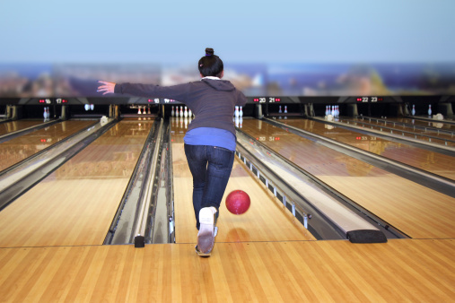 Young girl playing bowling