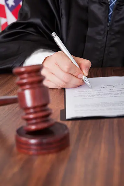 Photo of Male Judge Writing On Paper