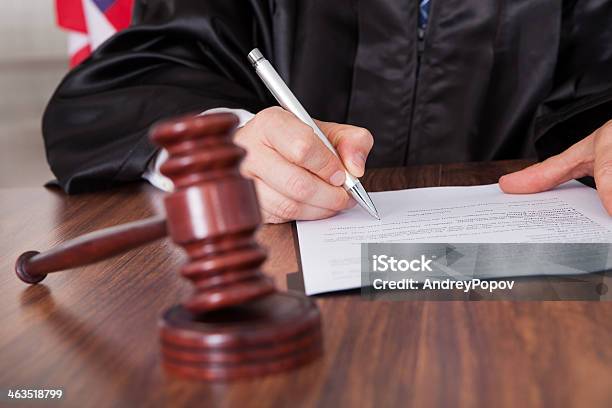 Male Judge Writing On Paper Stock Photo - Download Image Now - Judge - Law, Sentencing, Paper