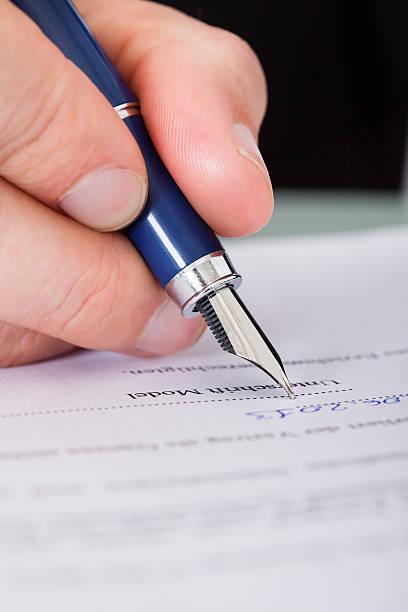 istock Businessman Writing With Ink Pen 463520637