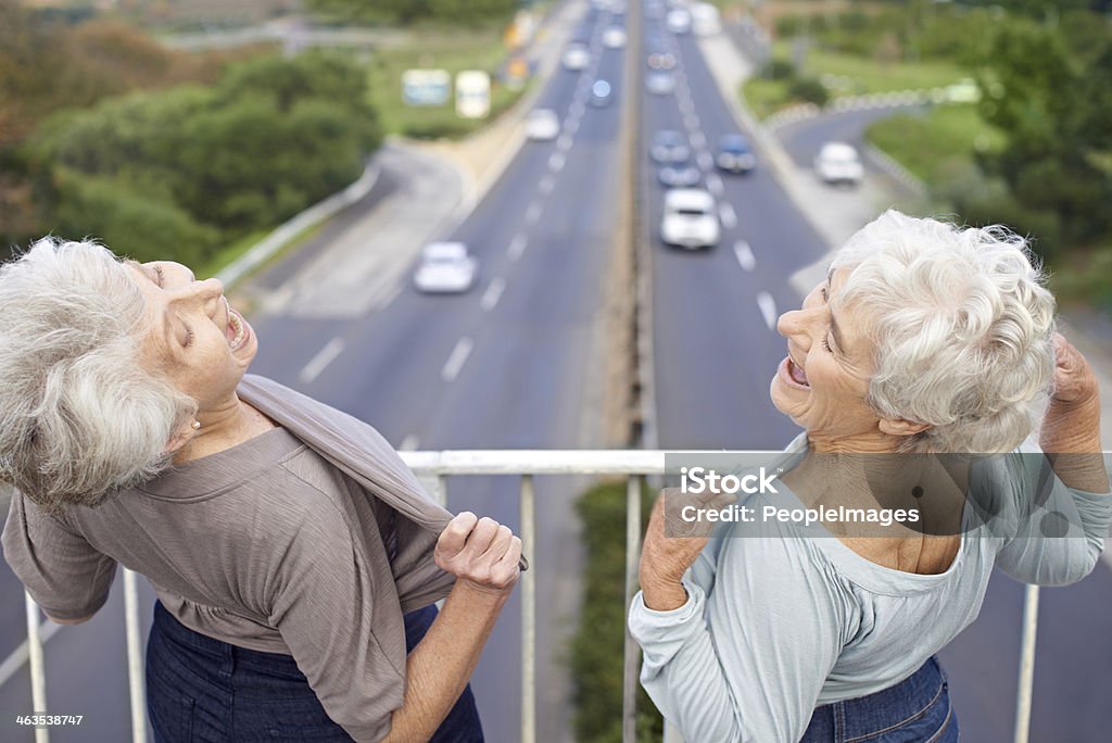 Get a look at this!! Two senior women flashing their chests at passers-by Humor Stock Photo