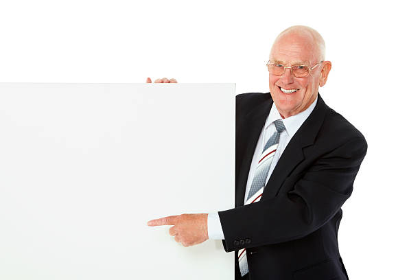 istock Happy elderly businessman showing you blank billboard 463539143