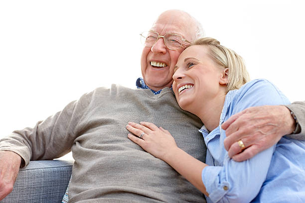 istock Elderly man embracing his daughter looking away smiling 463542385