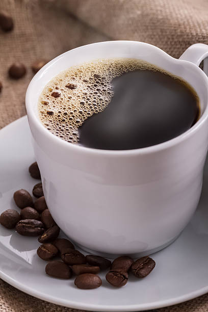 istock Cup of coffee with beans on the background. 463560173