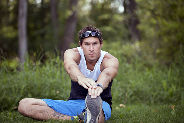istock Male athlete warming up and stretching 463560905
