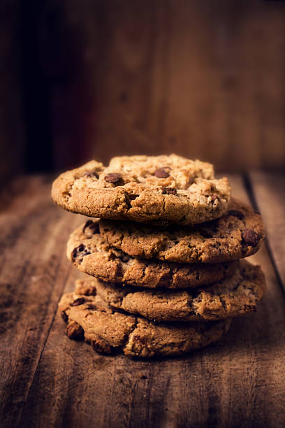 istock Chocolate cookies on wooden table. Stacked 463561835