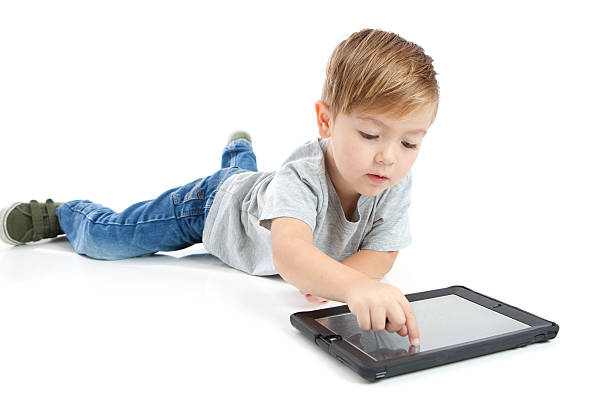 istock A preschool boy with a digital tablet on a white background 463580973