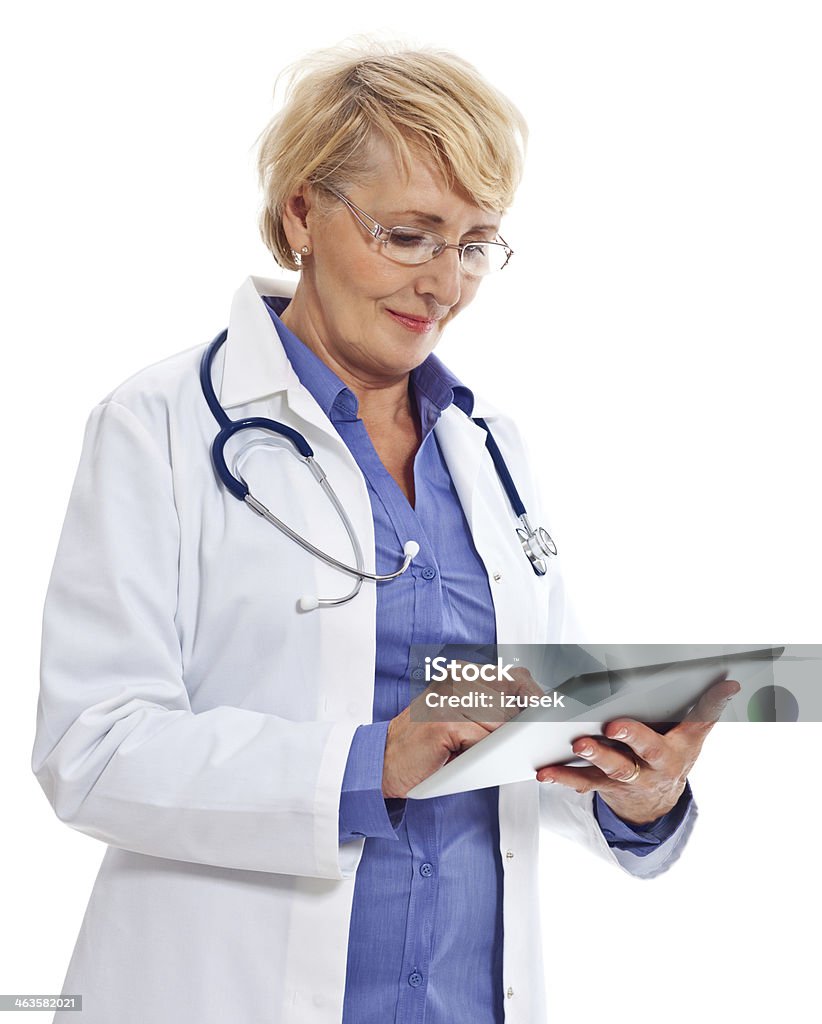 Mature Doctor with Digital Tablet Portrait of mature female doctor using a digital tablet. Studio shot on a white background. 60-64 Years Stock Photo