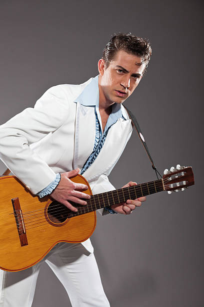 istock Retro rock and roll male guitar player wearing white suit. 463582577