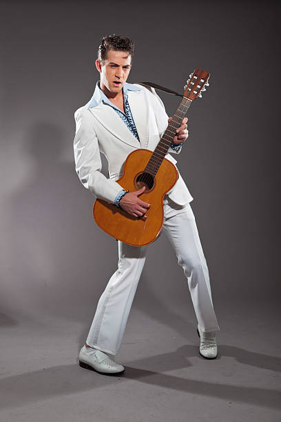 istock Retro rock and roll male guitar player wearing white suit. 463582587