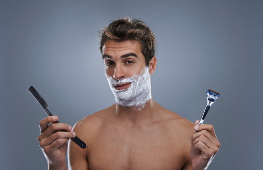 A young man shaving