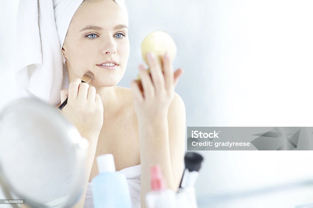 She knows how to disguise blemishes Shot of a woman applying foundation with a foundation make up brush with copyspace Dressing Table Stock Photo