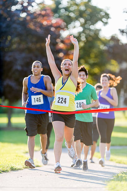 istock Female runner finishing a race 463588401