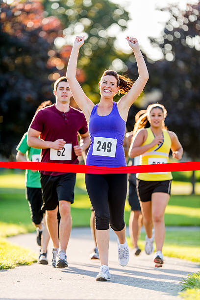 istock Female runner finishing a race 463588421
