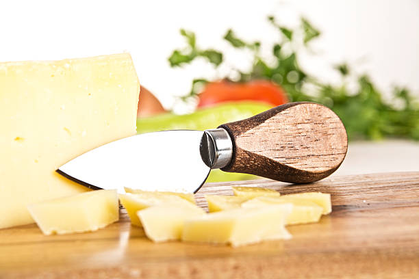 istock Cheese and knife on a wooden board 463589275