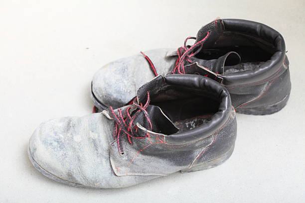 istock pair of old dirty work boots in building site 463599673