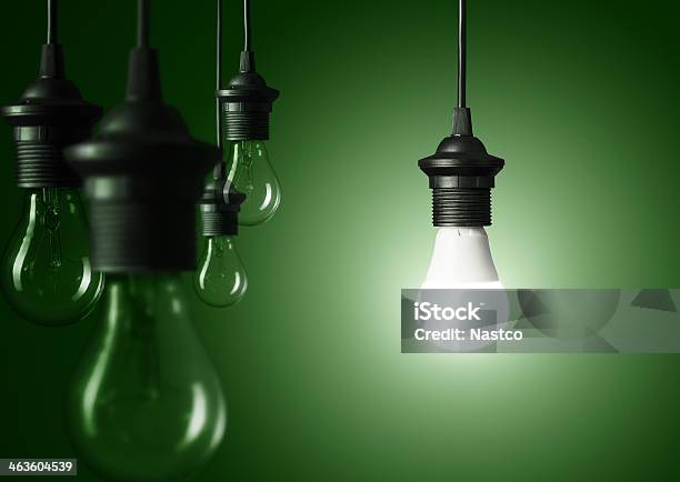 Standing Out Of The Crowd Stock Photo - Download Image Now - Light Bulb, Domination, Green Background