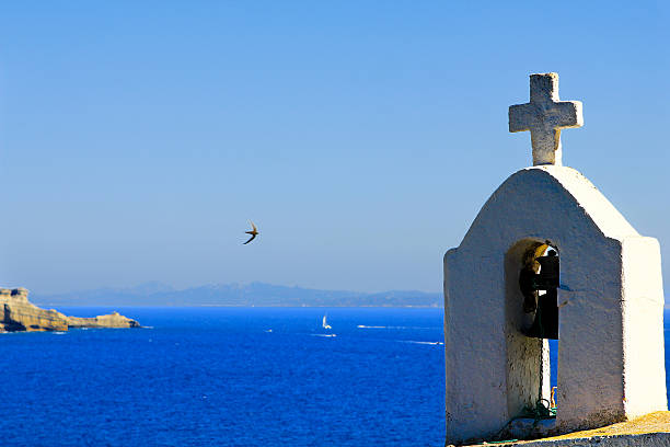 Bonifacio, crucifix with bell on the sea stock photo