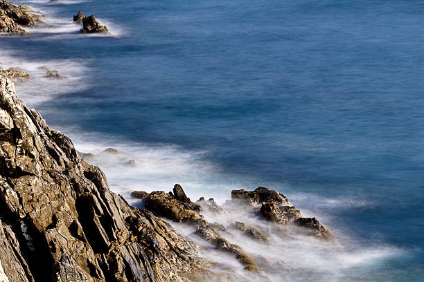 Sea foam on the cliff stock photo