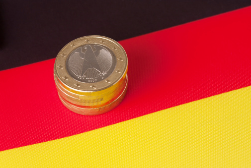Piggy Bank Textured with German Flag and Coins isolated on White Background. Finance and investment concept.
