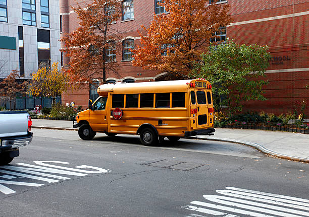 close-up of a yellow school bus on a Chicago street in the Loop district with the downtown buildings on a cold winter day