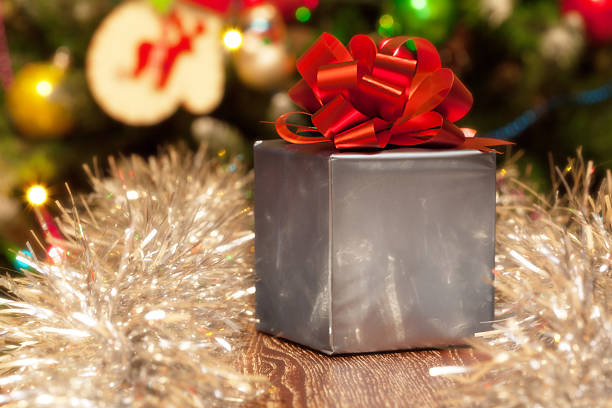 istock Gift box with red ribbon on Christmas festive background 463615041