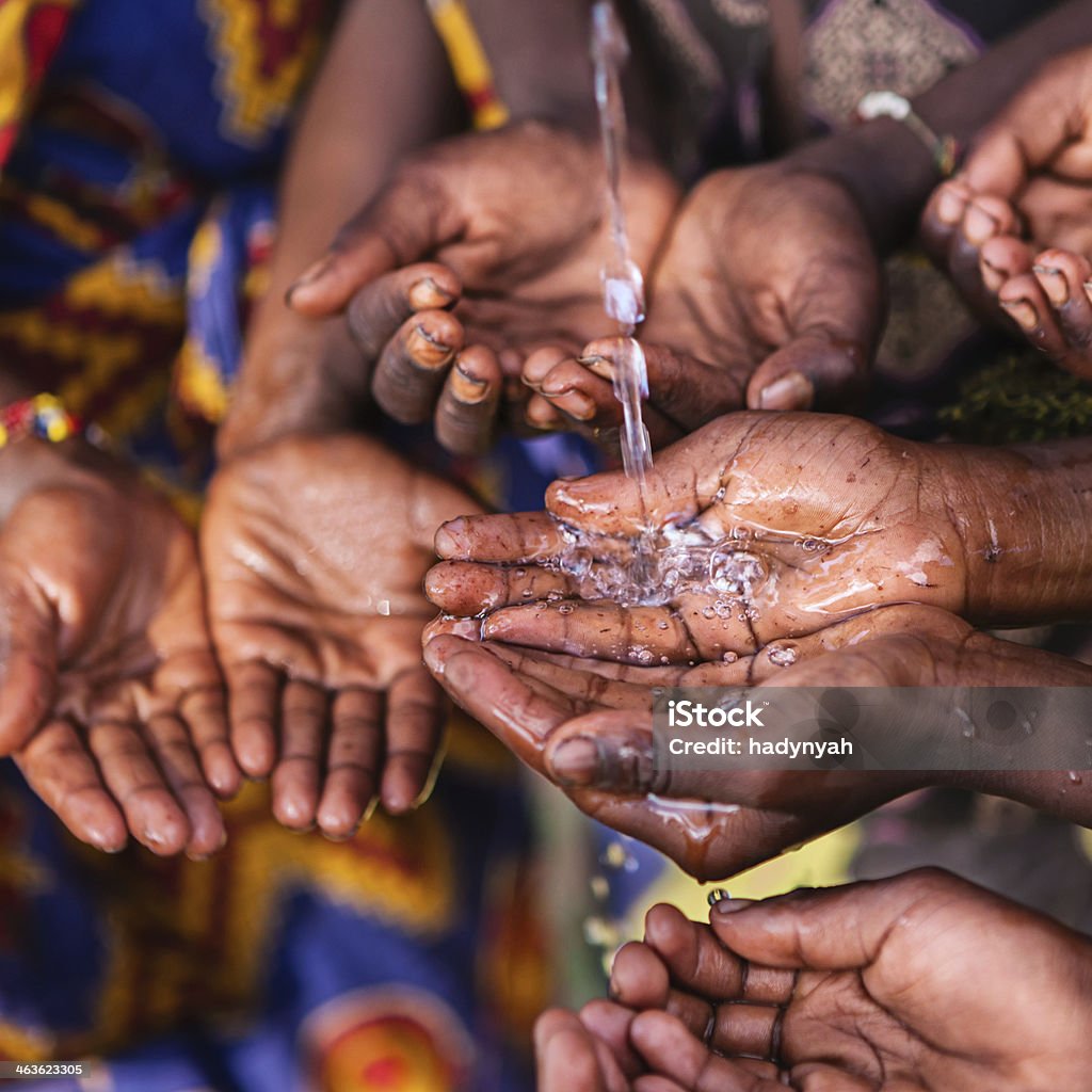 Hands of poor - asking for drinking water, Africa Poor African children keeping their hands up - asking for drinking water. Somalia Stock Photo