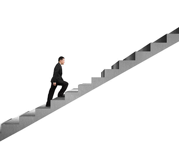 istock Businessman climbing on concrete stair isolated in white 463631859