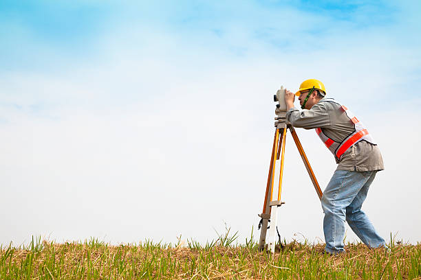 professional Surveyor engineer making measure  and checking on the field