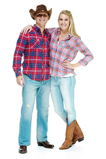 istock Cowboy smiling couple standing with hand on hip 463636239