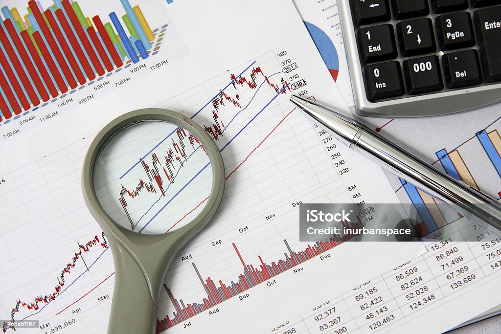 Business chart and tool Business marketing chart with magnifying glass and silver pen on table. Book Stock Photo