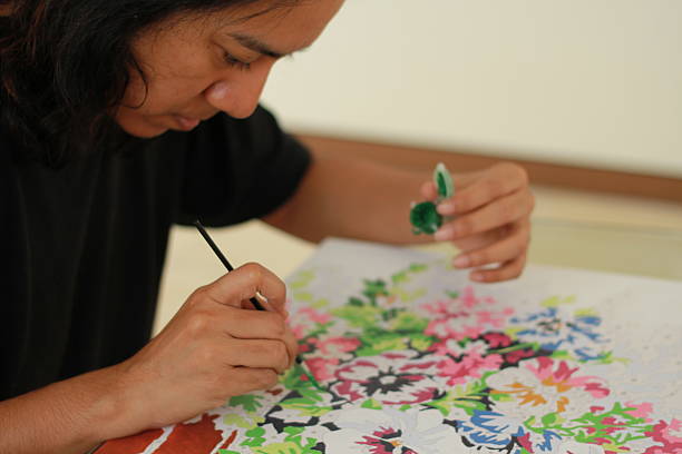 istock Asian woman painting 463659351