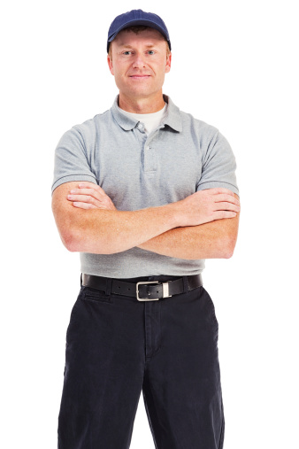 Photo of a handyman in a generic uniform, standing with arms folded; isolated on white.