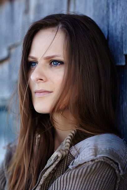 istock Beautiful woman leaning on a cabin log 463666533