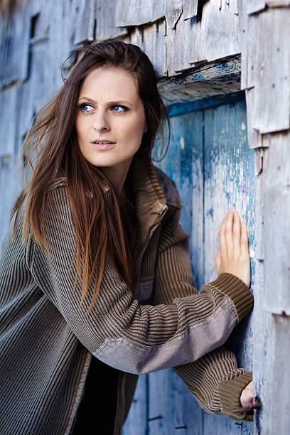 istock Scared woman pushing into a door 463666537