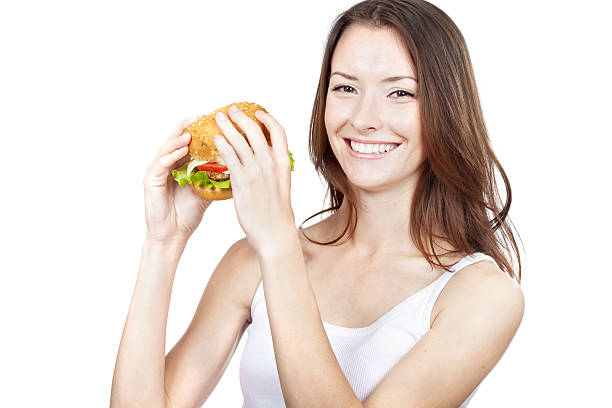 istock Beautiful young woman holding hamburger 463671347