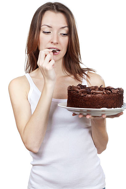 istock beautiful brunette woman eating chocolate cake 463672177