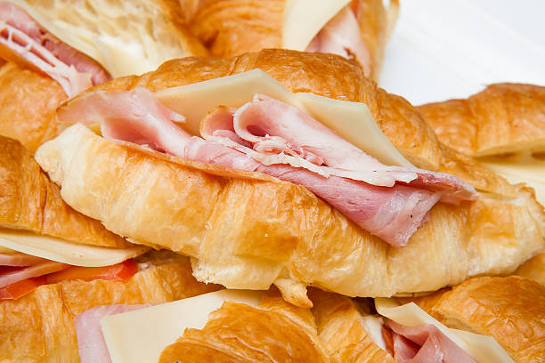istock croissant with ham and cheese on white plate 463674061