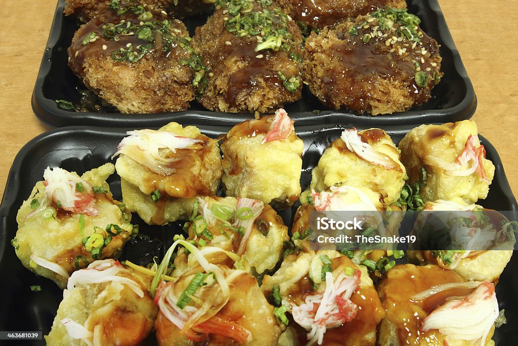 chicken Milanese with Teriyaki sauce and Japanese Dumplings chicken Milanese with Teriyaki sauce and Japanese Dumplings in black plate on wood table Asia Stock Photo