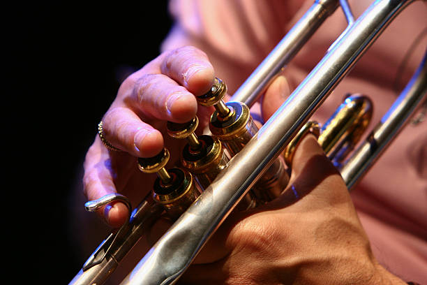 Fingers playing a lived trumpet