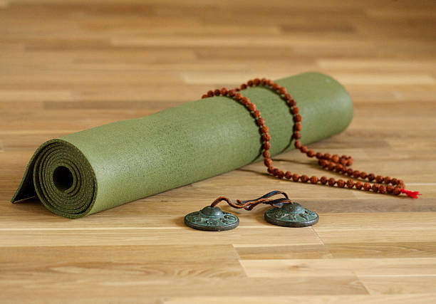 Yoga mat, Tingsha chimes and mala beads.