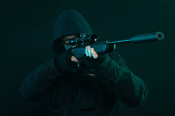 istock Sniper with beard in black holding gun. Studio shot. 463694939