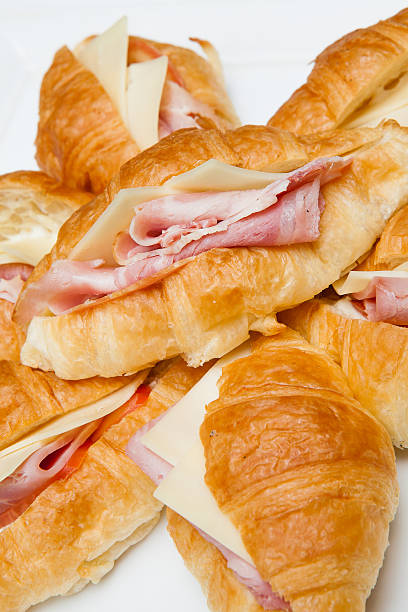 istock croissant with ham and cheese on white plate 463697915